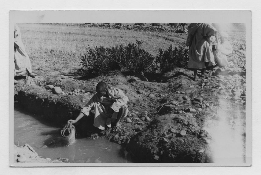 Glaoua [homme trempant un panier dans l'eau]